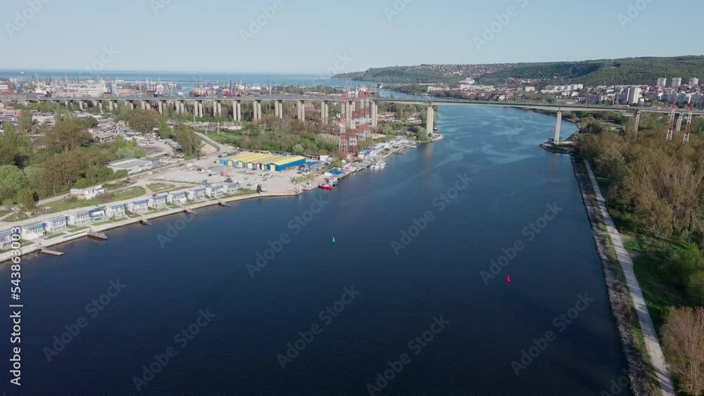 Bridge with cars passes over strait of Black Sea in city of Varna, with hotels and parks Bridge with cars passes over strait of Black Sea in city of Varna, with hotels and parks