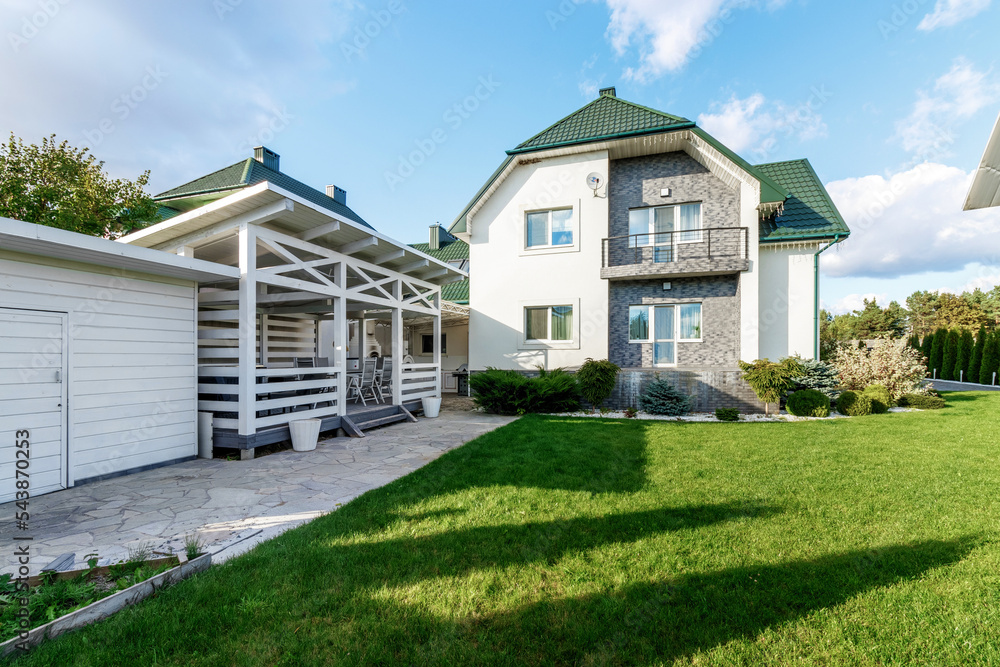 Beautiful house with a green lawn against a blue sky