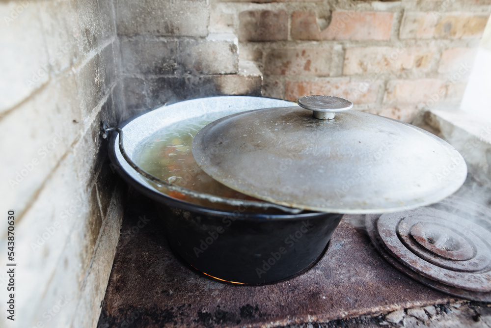 Cooking in the oven in the backyard. The fire is lit in a summer brick oven. Cooking in the oven in the backyard. The fire is lit in a summer brick oven.