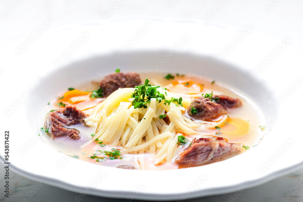 beef broth with noodles and carrot