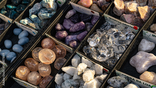 market stall of natural multicolored gemstones in boxes. Mineral stones for healing, altar, meditation, reiki, spiritual practice, ritual, witchcraft.