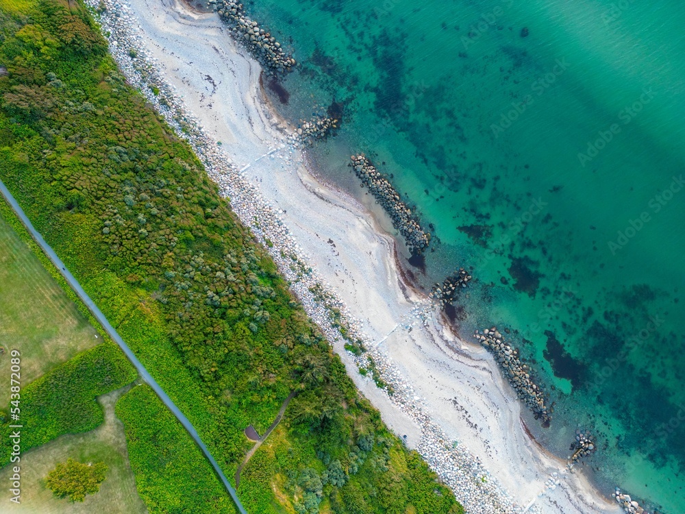 Fototapeta premium Aerial shot of Gilleleje beach with white sand and blue ocean water in Denmark