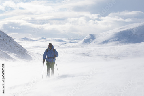 Snow shoe hiking on a sunny day in the mountains of Dovrefjell National Park photo