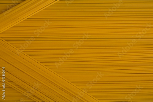 Spaghetti pasta Italian cuisine food. Yellow long spaghetti food background 