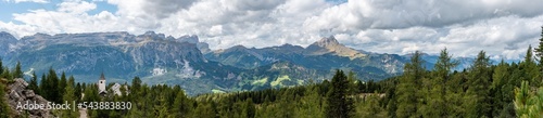 Panoramic landscape of the Dolomite Alps and the Heilig Kreuz church, South Tirol
