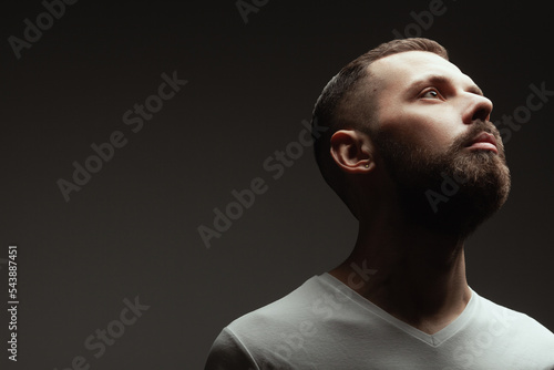Wallpaper Mural Male beauty concept. Profile portrait of proud charismatic active 30-year-old man posing over dark gray background. Perfect haircut. Hipster style. Close up. Copy-space. Studio shot Torontodigital.ca
