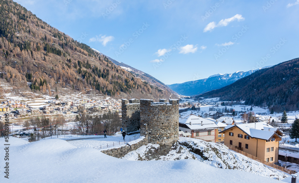 St. Michael castle in Ossana stands on a rocky outcrop. Ossana castle in the village of Ossana in winter season - Sole Valley, Trento province, Trentino Alto Adige, northern Italy - december 7, 2021
