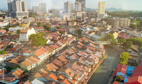 Melaka, Malaysia. Aerial view of city homes, river and skyline from drone on a clear sunny day.