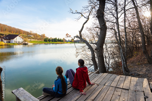 Girl and girl enjoy the view near the mountain lake