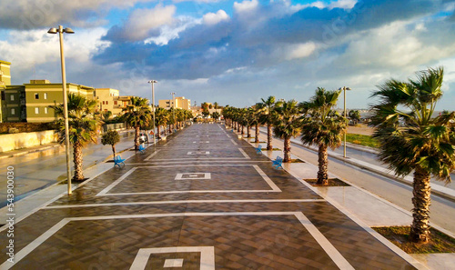 Aerial view of Mazara del Vallo city promenade along the ocean, beautiful coast of Sicily at sunset from drone.