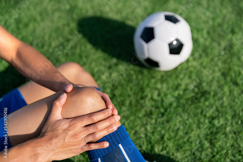 football soccer player accident knee injury sport treatment on champion league final match competition with ball on grass in stadium