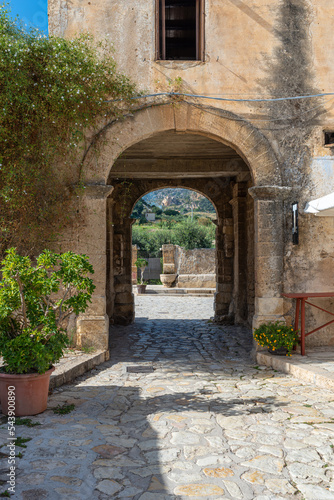 Passageway to the picturesque courtyard or baglio with gastronomy in the village Scopello on Sicily. A hamlet of houses clustered around a common courtyard