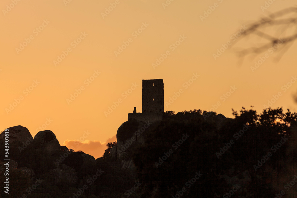 suggestive image of castle Pedres in Olbia, Sardinia, at sunset.