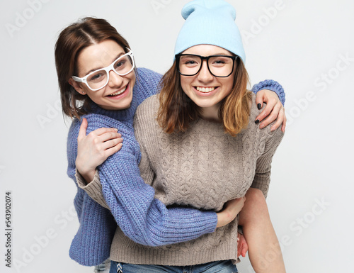 cheerful young friends women iwearing casual hugging and having fun photo