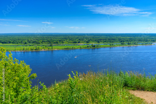 Fototapeta Naklejka Na Ścianę i Meble -  View of the river Kama and the bank of the river covered with dense forest from a high hill