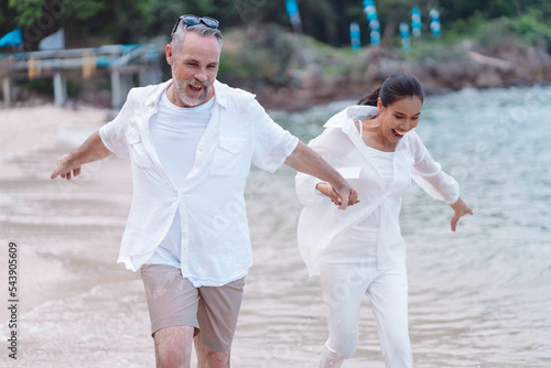 Couple senior elder retire resting relax walking running at sunset beach honeymoon family together happiness people lifestyle