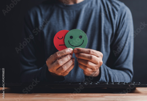 Canvas Print Man Hands holding sad face hiding or behind happy smiley face, bipolar and depression, mental health concept, personality, mood change, therapy healing split concept