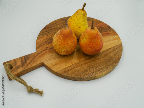 Three spotted autumn pears on a wooden table