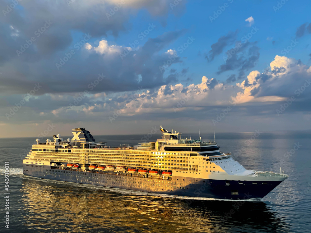 Luxury cruise liner sailing during sunset