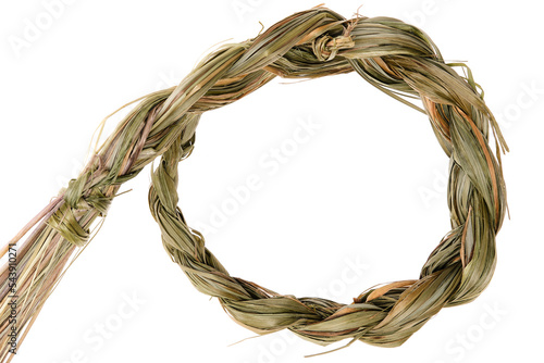Sweet grass braid (Hierochloe odorata), also called vanilla grass, used by indigenous peoples in North America as herbal medicine and incense (smudges) to attract good spirits. Close up, top view.