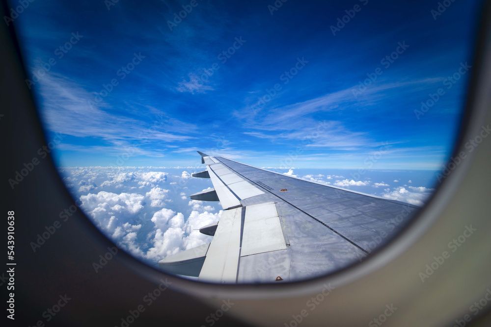 Wing of an airplane flying above the clouds look from cabin window. Wing of an airplane flying above the clouds look from cabin window.