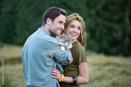 Photography couple hugging wild gray cat