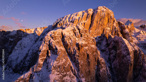 sunset in the mountains covered by snow