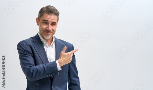 Business portrait of confident businessman. Salesman showing pointing at blank space. Entrepreneur in jacket smiling, Happy mid adult, mature age man standing, smiling, isolated on white background.