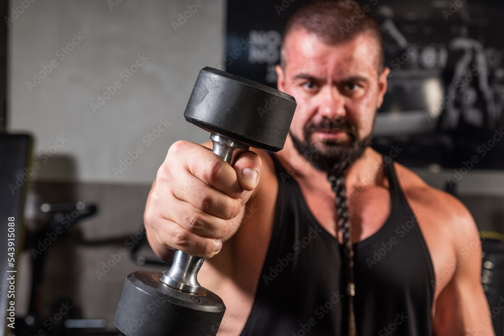 Strong man is training in the gym