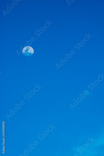 white full moon against evening blue sky in Brazil