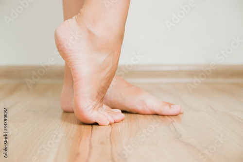 The dry skin on the heel is cracked. Closeup dehydrated skin on the heels of female feet. Treatment concept with moisturizing creams and exfoliation for healing wounds and pain when walking.