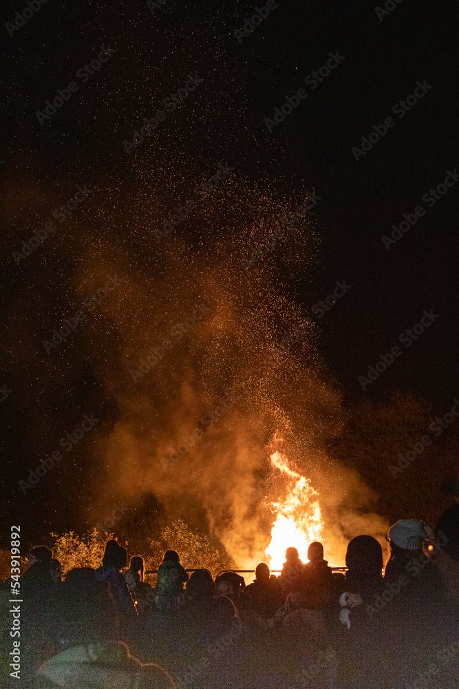 Crowd Stood In Front Of A Roaring Bonfire