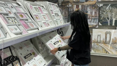 Beautiful brunette girl photo frame in the supermarket. Ukraine, Kyiv July 2022 photo