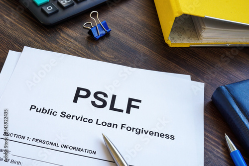 Papers foe Public Service Loan Forgiveness PSLF on the wooden surface.