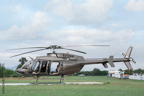 Beautiful modern helicopter on helipad in field