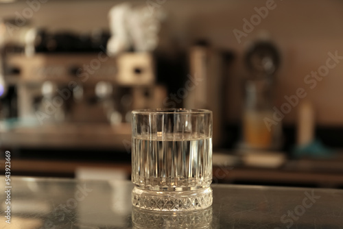 Glass with water on countertop in cafe