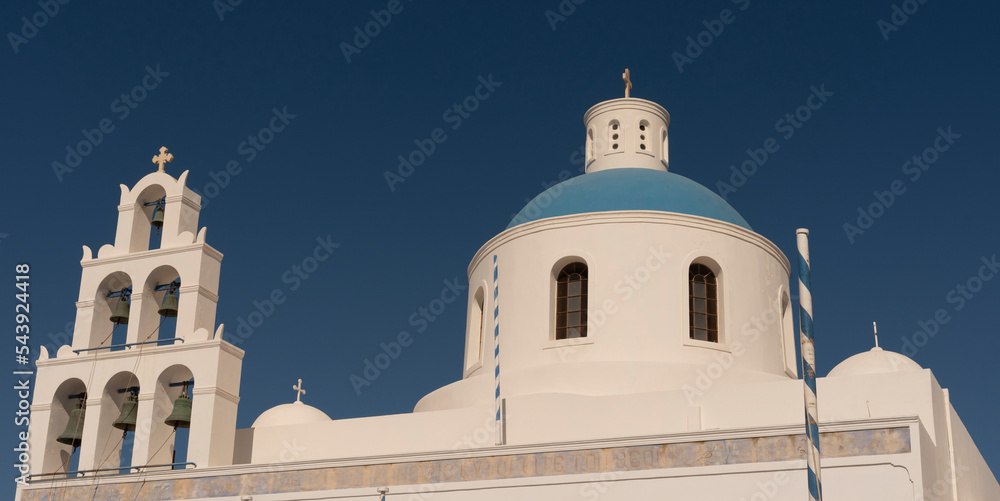 OIA, Santorini, Greece. 2022. Greek Orthodox church, Chiesa de Panagra Akathistos Hymn with blue dome and bells. Oia Santorini.