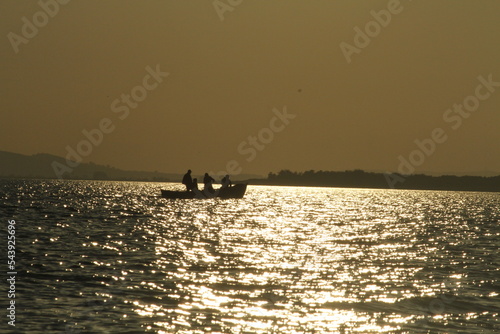 sunset, sea, boat, water, sky, sun, ocean, ship, sunrise, yacht, silhouette, fishing, sailing, travel, orange, sailboat, nature, horizon, beach, summer, dusk, landscape, sail, lake, dawn