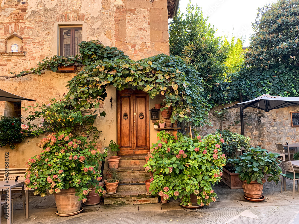Pienza, Tuscany, Italy. Old house facade in Pienza. Beautiful Italian street of small old provincial town. Street view and facade of old house. Villages in Val dOrcia national park. Woode