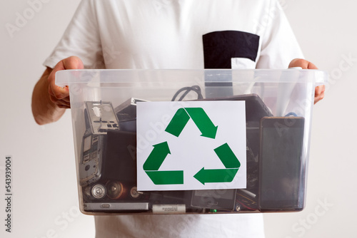 Household electrical and scrapped electronic devices in recycle container. Sorting, disposing and recycling. Waste Electrical and Electronic Equipment. Hazardous E-Waste Recycling. 