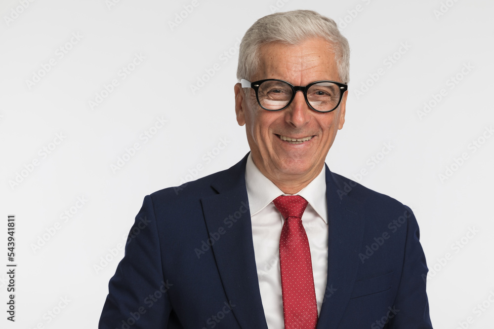 Old businessman smiling at the camera, wearing eyeglasses