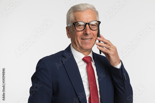 Old businessman talking on the phone