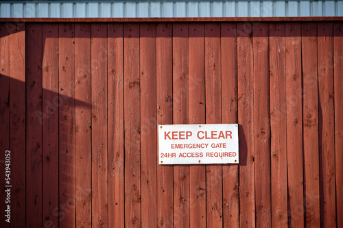 Keep clear emergency access required sign on wall