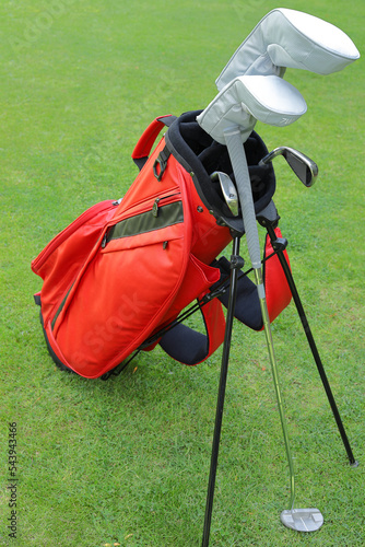 Red golf set on green grass background