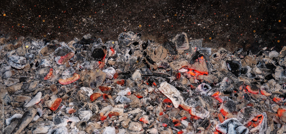 Burning charcoal. Flaming coal close-up. Sparks from the fire Burning charcoal. Flaming coal close-up. Sparks from the fire