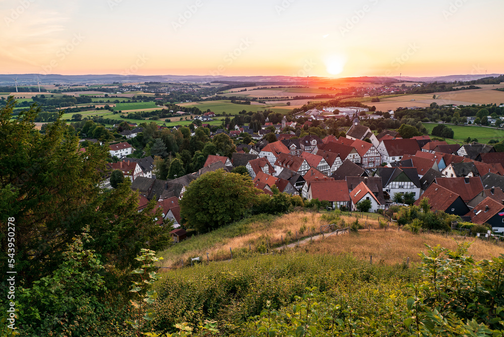 Elevated view of the half-timbered houses of Schwalenberg village in warm evening light, Teutoburg Forest, Germany