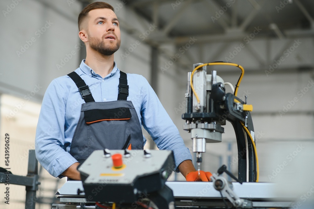 Male factory mechanics or Engineer in safety uniforms are working on metal drilling machines in industrial production lines, steel processing industry, mechanical maintenance. Male factory mechanics or Engineer in safety uniforms are working on metal drilling machines in industrial production lines, steel processing industry, mechanical maintenance.