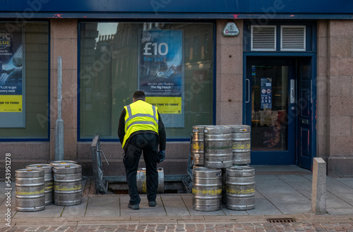 3 November 2022. Peterhead, Aberdeenshire, Scotland. This is a man stocking a beer cellar from the pavement in Peterhead Town centre. photo