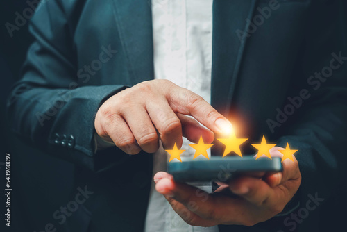 hand of customer or client holding the stars to complete five stars. with copy space. giving a five star rating. Service rating, satisfaction concept.