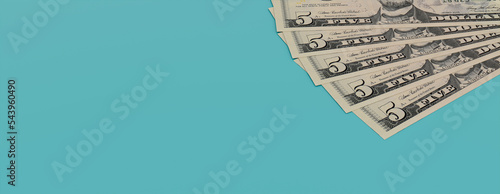 Five Dollar Bills on a Turquoise surface. Finance concept Banner with copy-space.